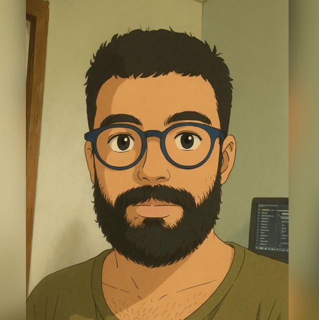 Wendryl Santos - Um jovem com barba e óculos azul.